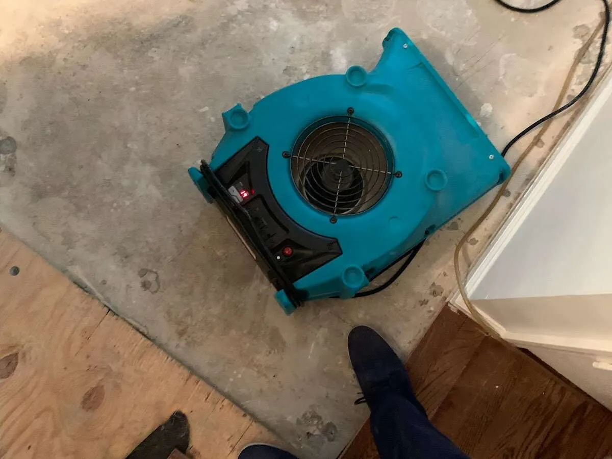 Air mover drying subfloor during Commercial Water Damage Restoration in Tulsa